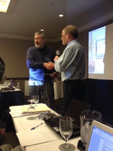 Tom presents Mike with a gavel award